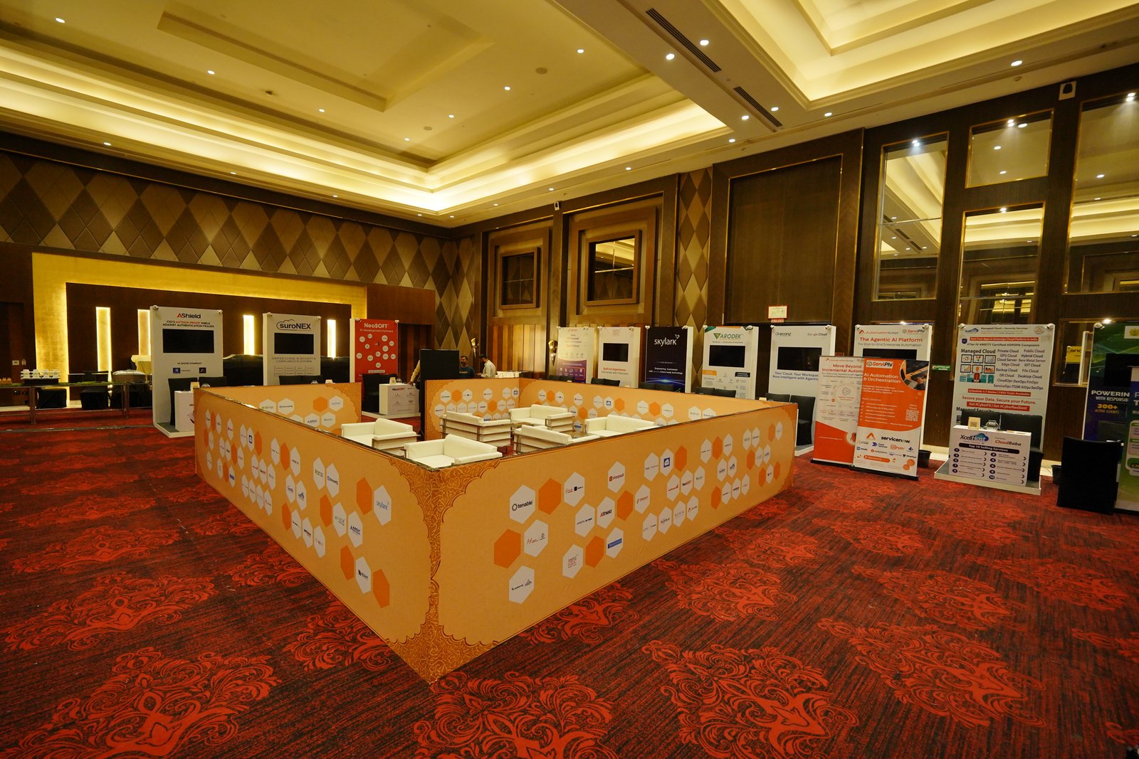 Precision-engineered custom stall structure with backlit panels and branded signage at expo