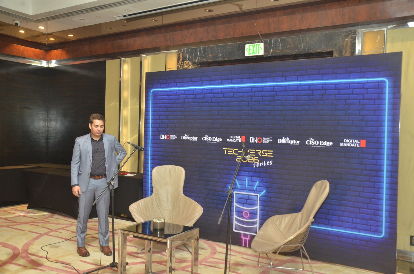Modern trade show exhibition booth with branded panels and product displays in well-lit expo hall
